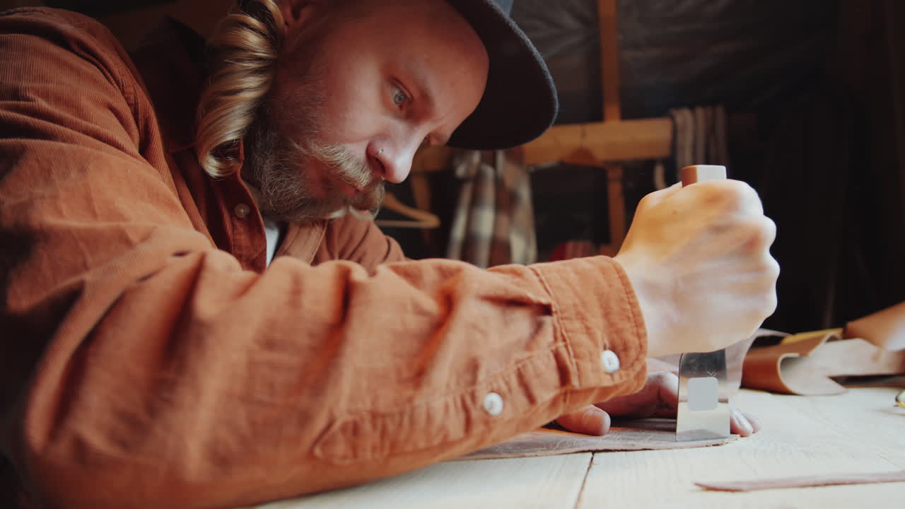 Craftsman Cutting Leather at Worktable