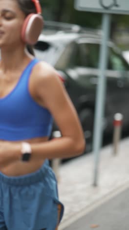 woman running outdoors with headphones