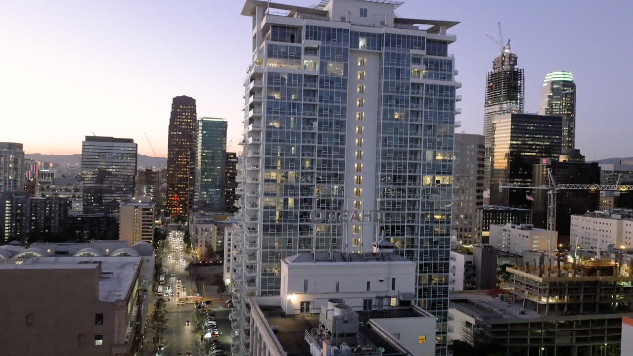 Cityscape at Dusk: Downtown Urban Skyline with High-Rise Buildings and Traffic