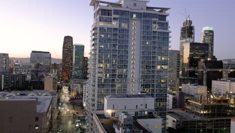 cityscape at dusk: downtown urban skyline with high-rise buildings and traffic