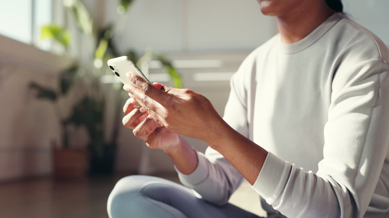 Woman using her phone while sitting indoors