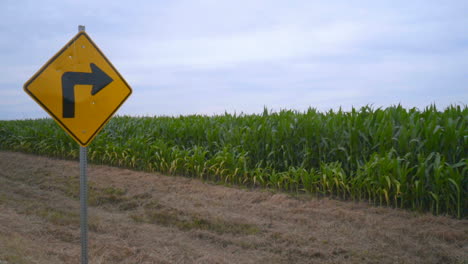 road sign pointing to wind turbine. wind turbine on farm field