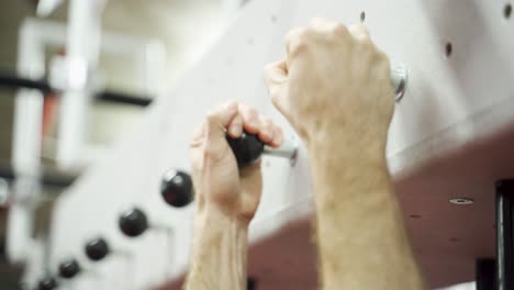 hands gripping on climbing bolts. man climbing. close up