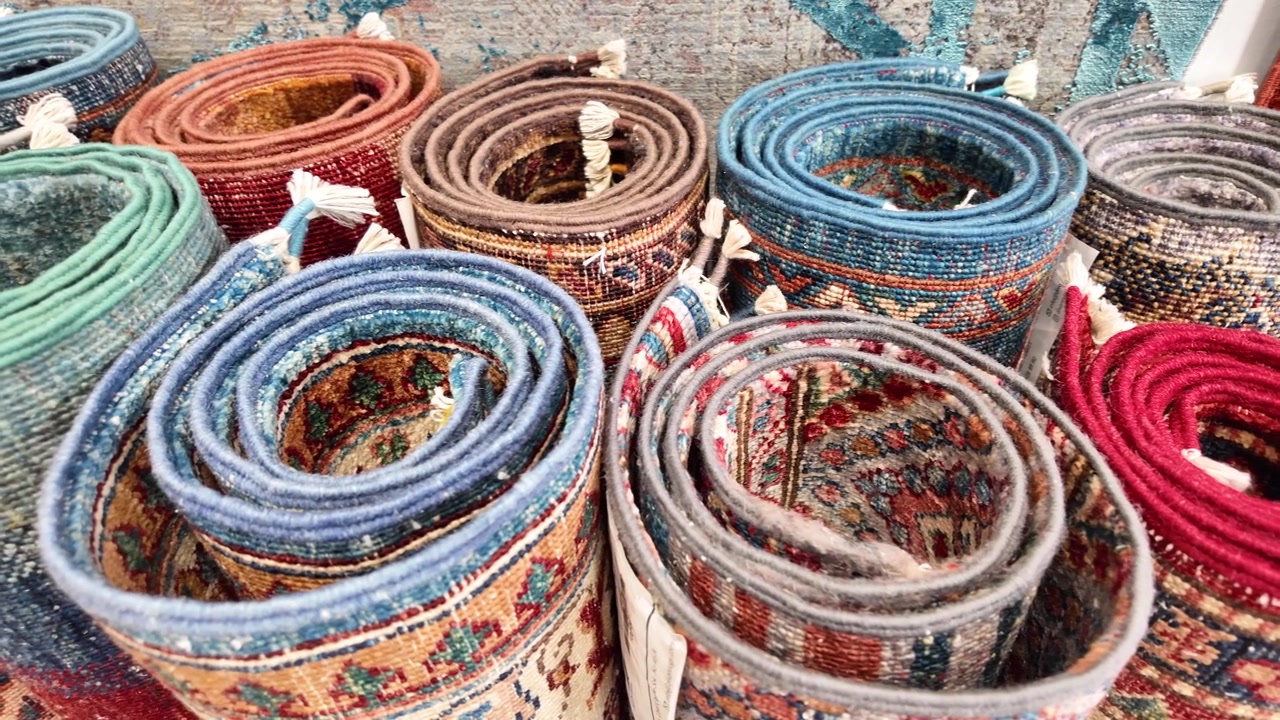 Close-up of Rolled Traditional Carpets with Vibrant Patterns