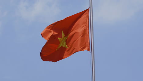 4k-Video-of-National-Flag-of-Vietnam-in-bright-sun-with-blue-sky-and-cloud-background