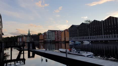 Looking-over-a-grid-of-fence-on-the-river-Nivelda-in-Trondheim,-Norway