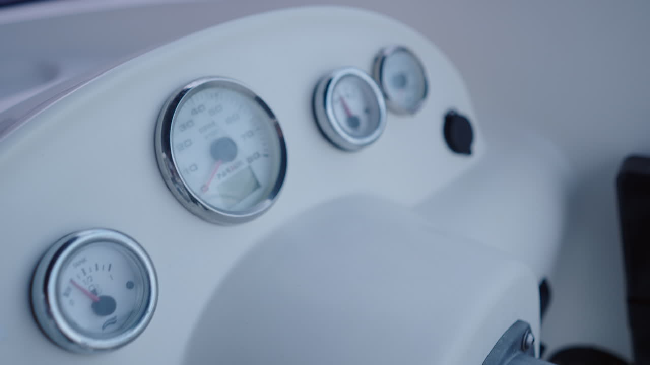Close-up of a boat's dashboard with gauges