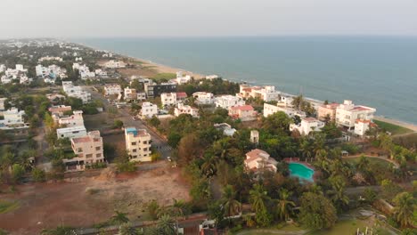 ecr chennai near beach surrounded by trees, construction and buildings top view during sunset