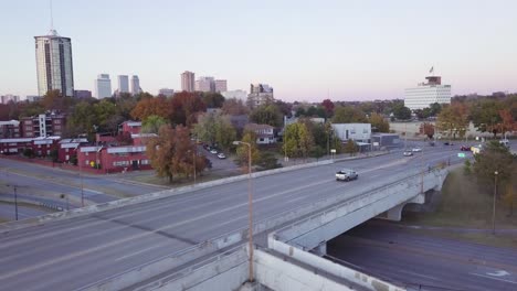 aerial drone footage of downtown tulsa crossing the arkansas river at dusk.