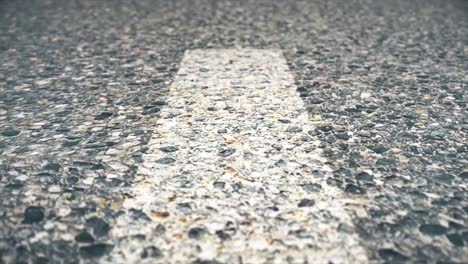 close-up view of asphalt road surface with gravel