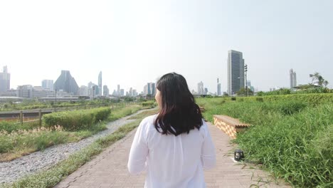 an asian woman in public park.