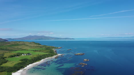 aerial shot of the beautiful blue sea and costal beaches, around the isle of islay in scotland