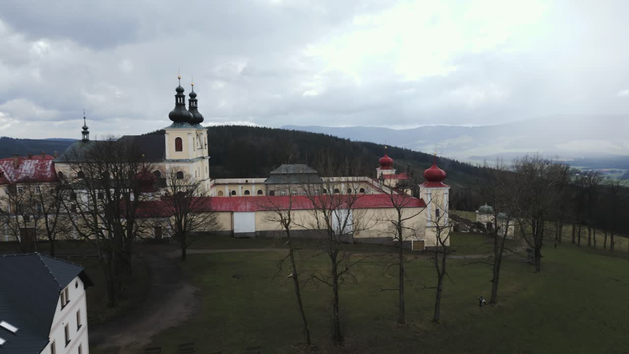 Aerial perspective of the Hedeč pilgrimage site, highlighting the magnificent Mother of God monastery nestled on the mountaintop, providing a breathtaking view of the Czech Republic