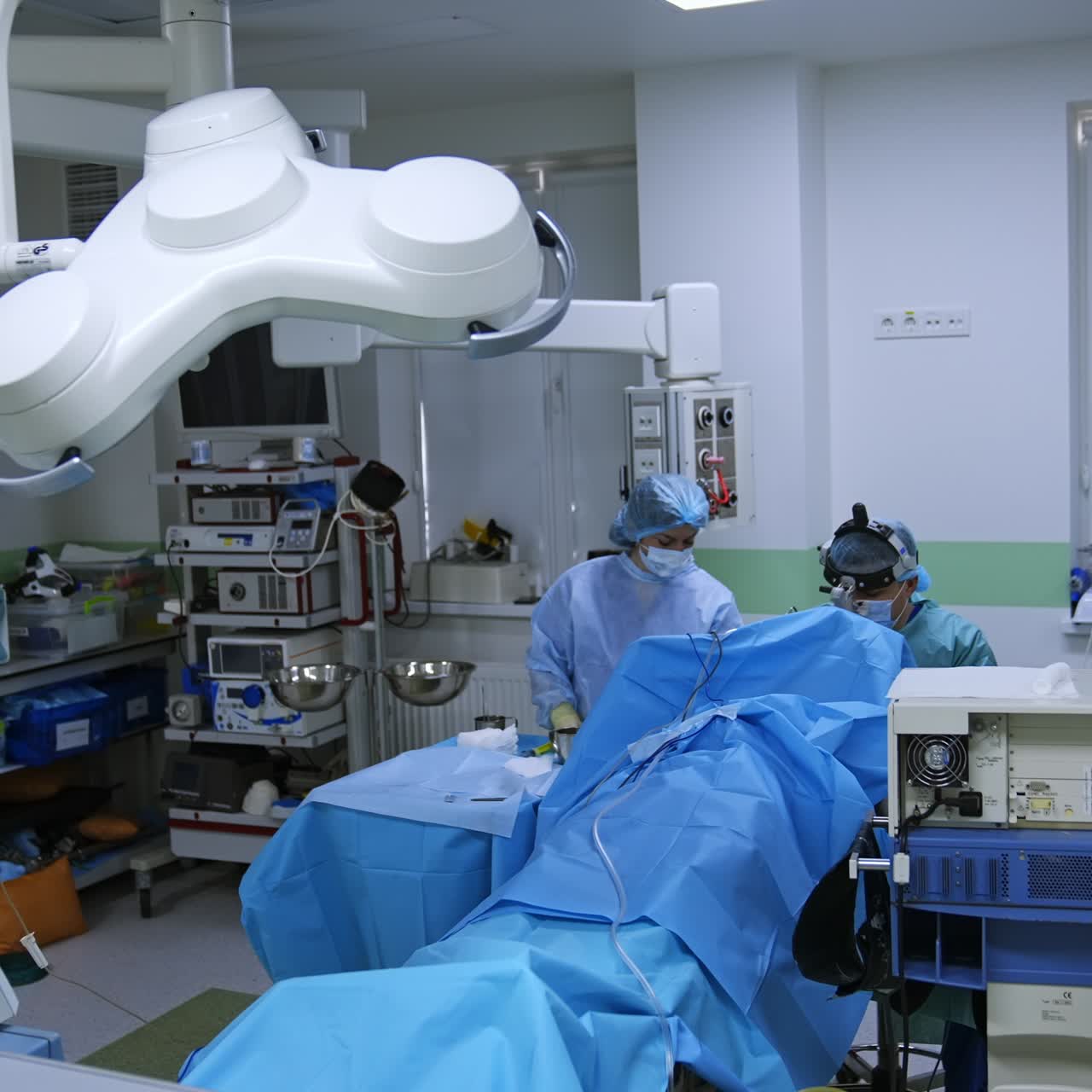 Surgical procedure conducted in the modern operational room. Doctor assisted by a nurse performs surgery