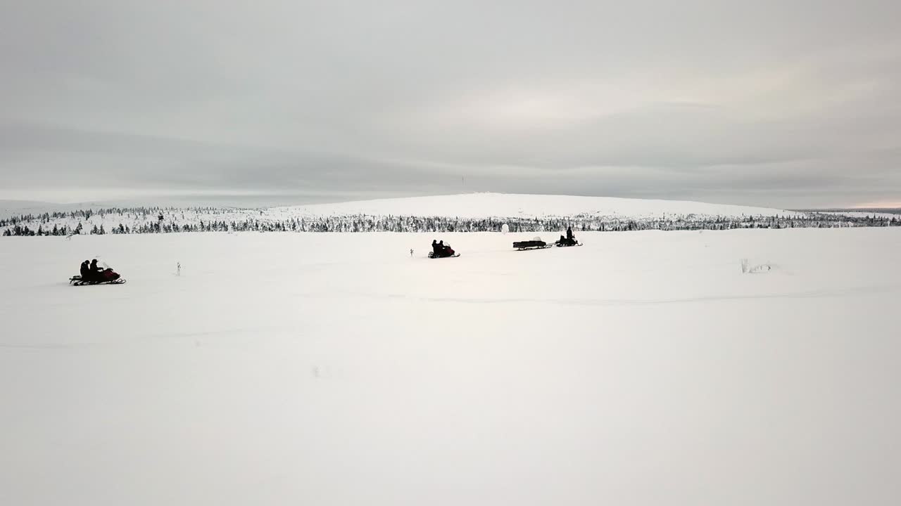 Drone view of snowscootering in Saariselka, Lapland, Finland