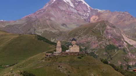 aerial establishing shot above gergeti trinity church in summer