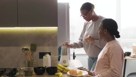 women preparing smoothie