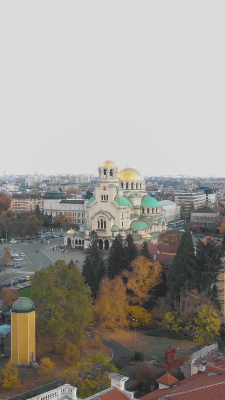 Aerial view of the magnificent Alexander Nevsky Cathedral in Sofia, Bulgaria, surrounded by autumn foliage. Vertical Video