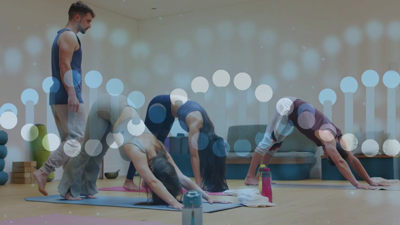 instructor walking mats guiding while yoga class holding down dog with bokeh appearing then fading