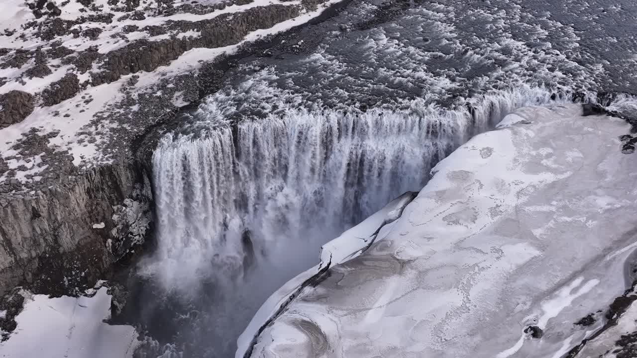 Dettifoss waterfall in Iceland captured in slow motion from a drone during winter.