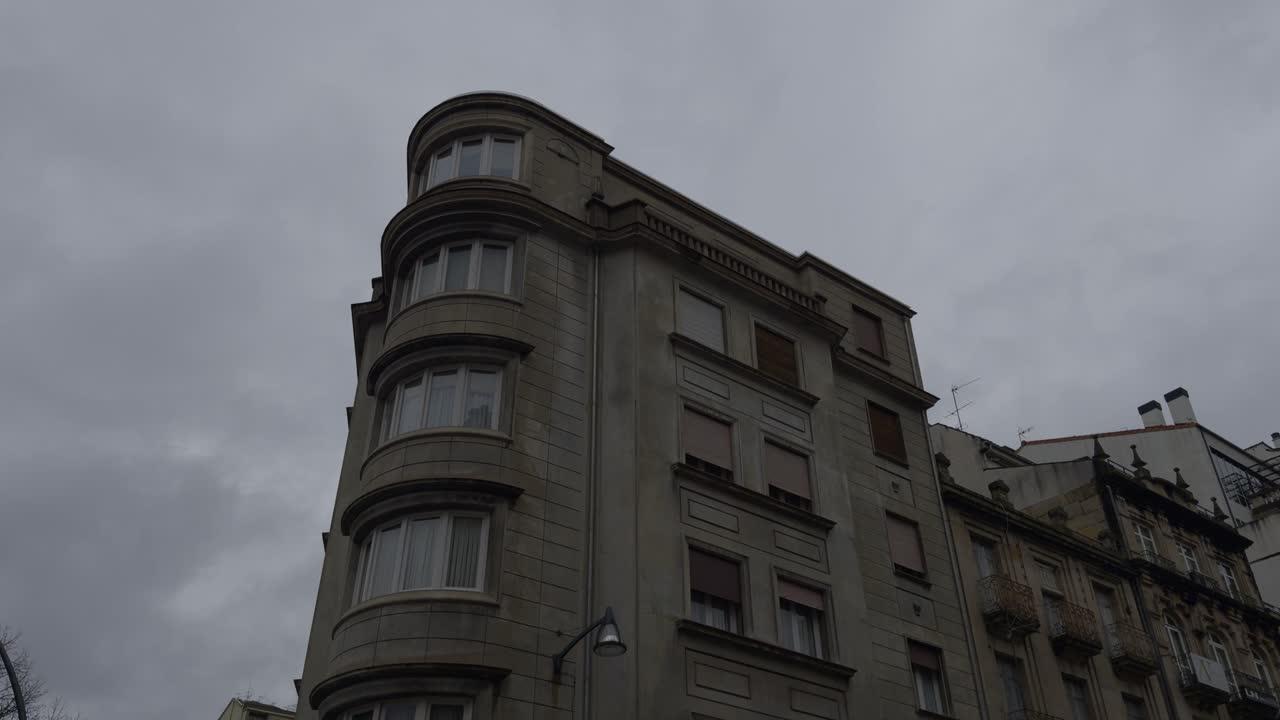 Beautiful Beige Apartment Building With Brown Shutters On A Cloudy Day