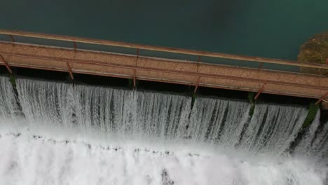 waterfall dam - fast lift off angle from drone looking down