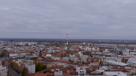 aerial footage of a smokestack chimney of an energy plant in belgrade, serbia on a cloudy day