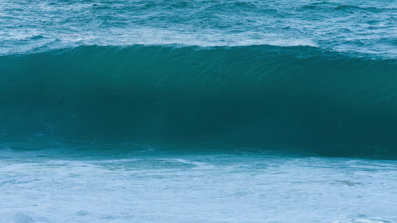 Close-up of boiling pot on a camp stove against a misty Cornwall coast. Grass, stones, and a calm sea set a serene mood in this outdoor cooking adventure scene