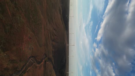 wind turbines over landscape of wind farm during sunset, south australia, vertical footage