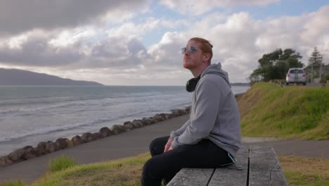 a video of a man wearing son glasses on a bench