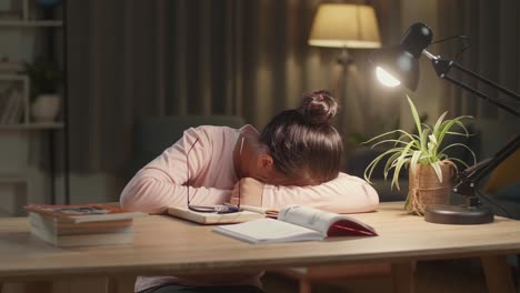 tired student taking a nap during night study