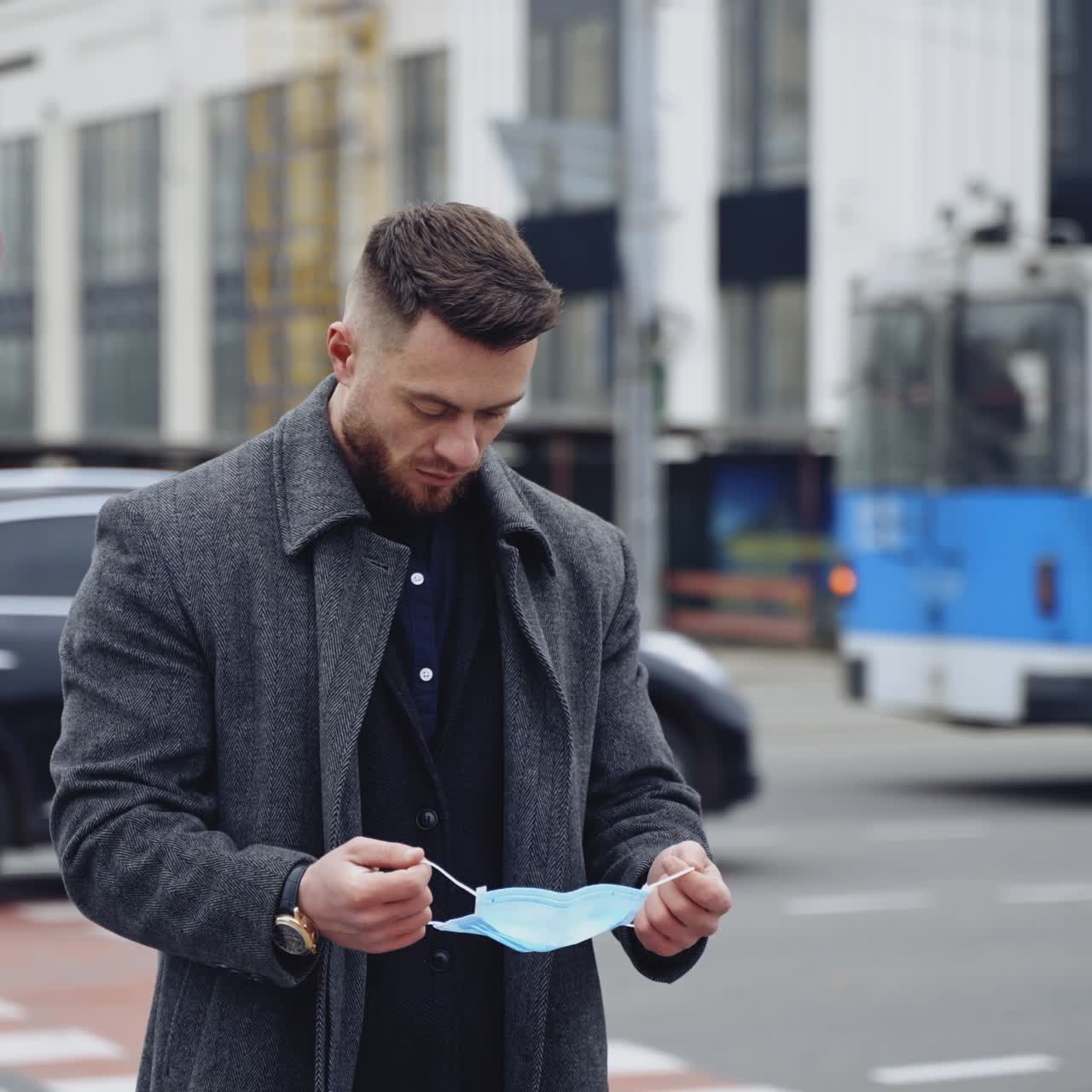Young man putting on protective mask. Portrait of a young man wearing safety mask during pandemic in the city. Virus protection.Covid-19. Epidemic Coronavirus.