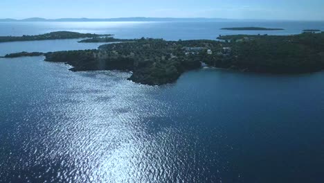 Cinematic-rotating-up-high-4K-drone-clip-over-the-tropical-blue-waters-of-Toroni-in-Chalkidiki