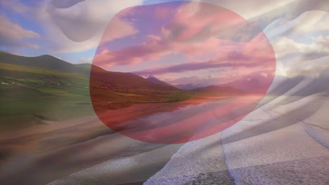 composición digital de la bandera de japón ondeando contra la vista aérea de la playa y las olas del mar