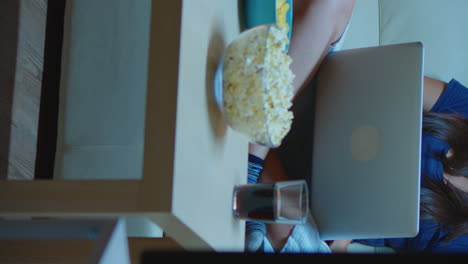 vertical video: woman watching tv and feeling bored