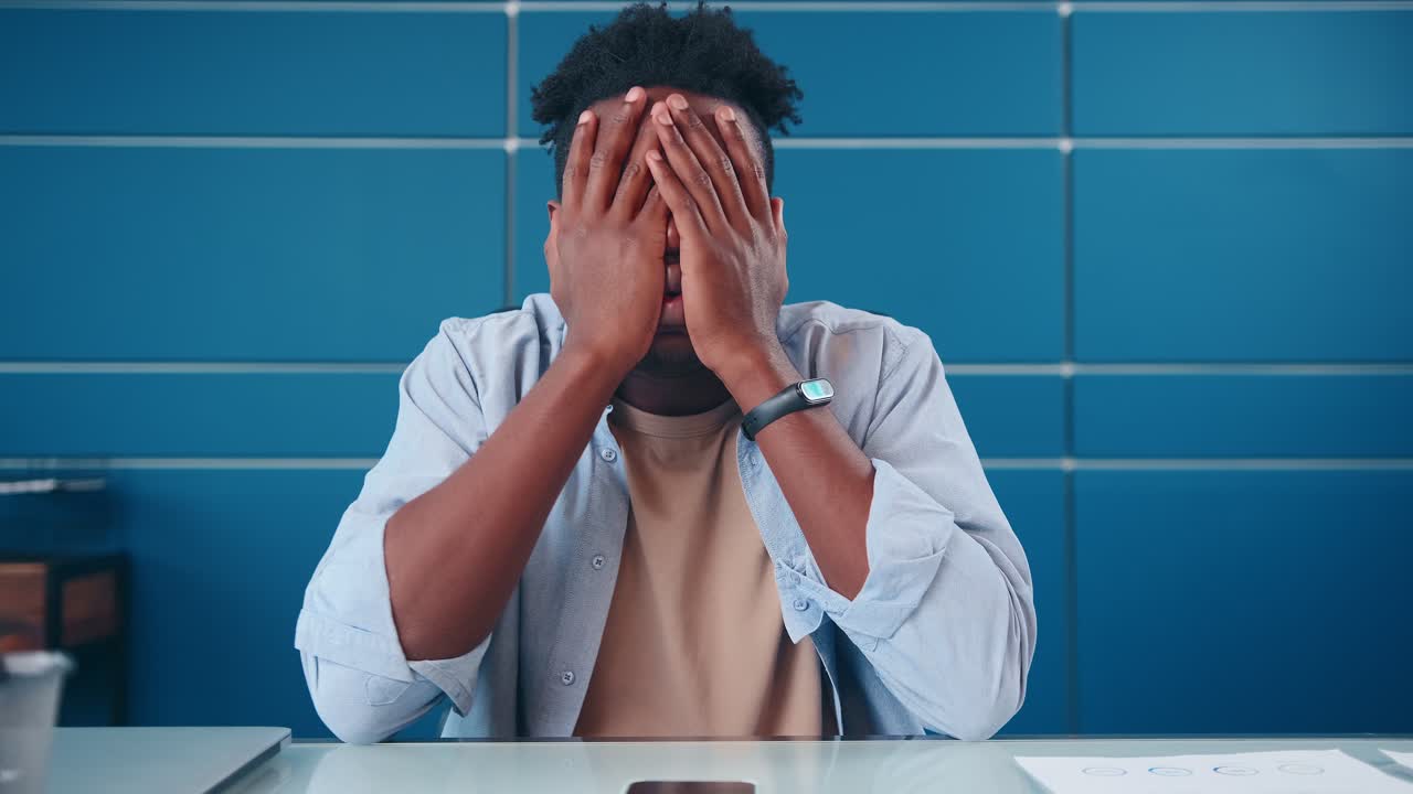 Young annoyed african american man get angry after seeing message on phone