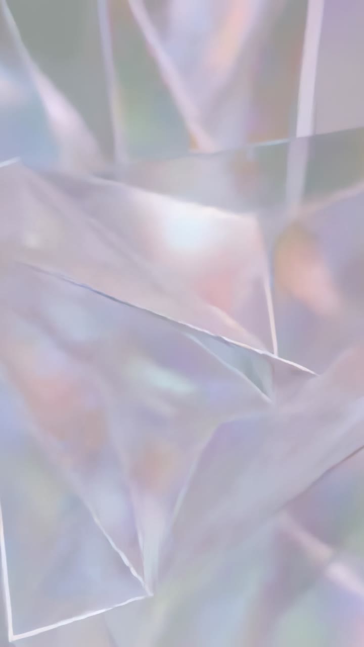 Vertical video: Shifting camera showing prism facets sliding across macro set, specular pastel glow