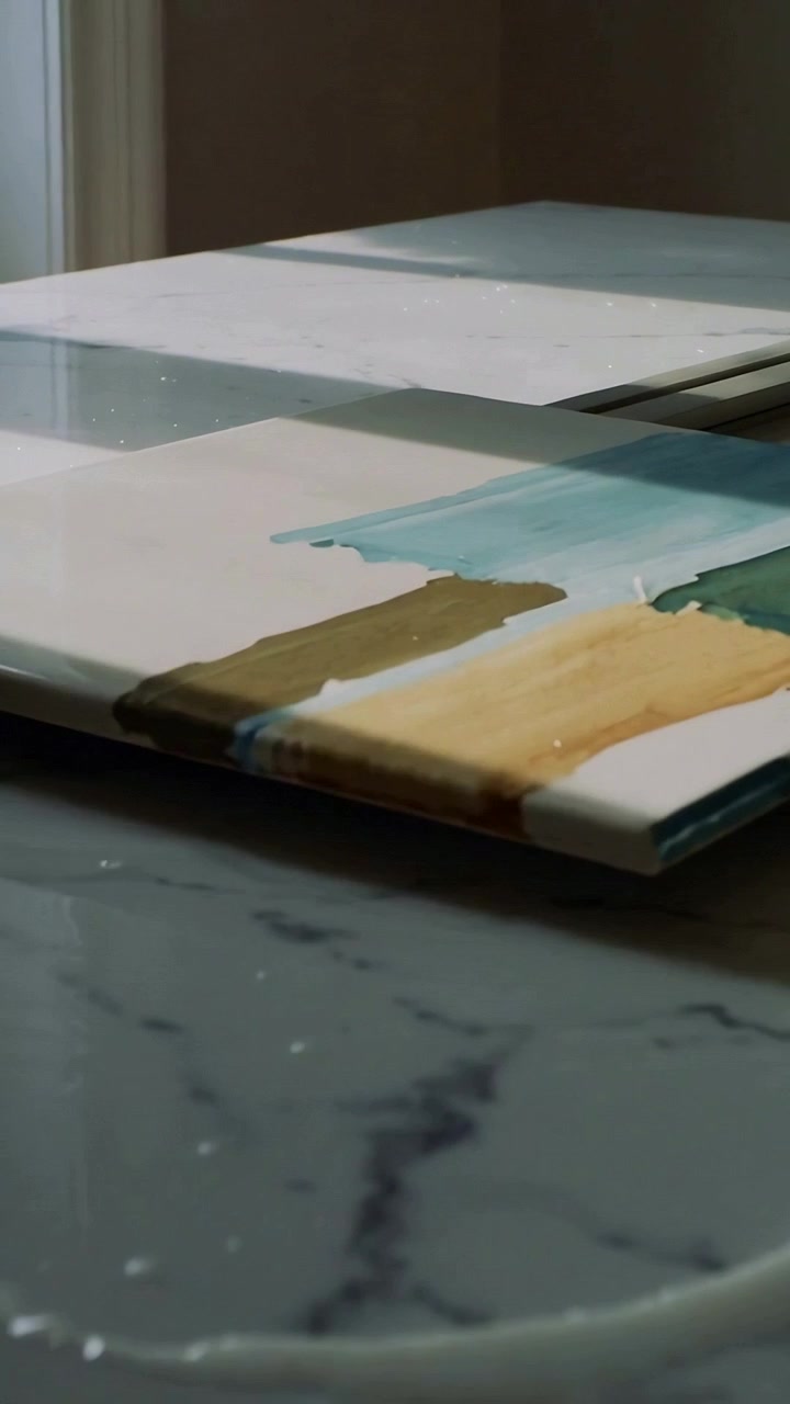 Vertical video: Camera panning tiles showing teal green brown swatches on marble top to check tones
