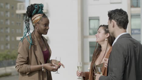 happy women laughing with business partner at rooftop party