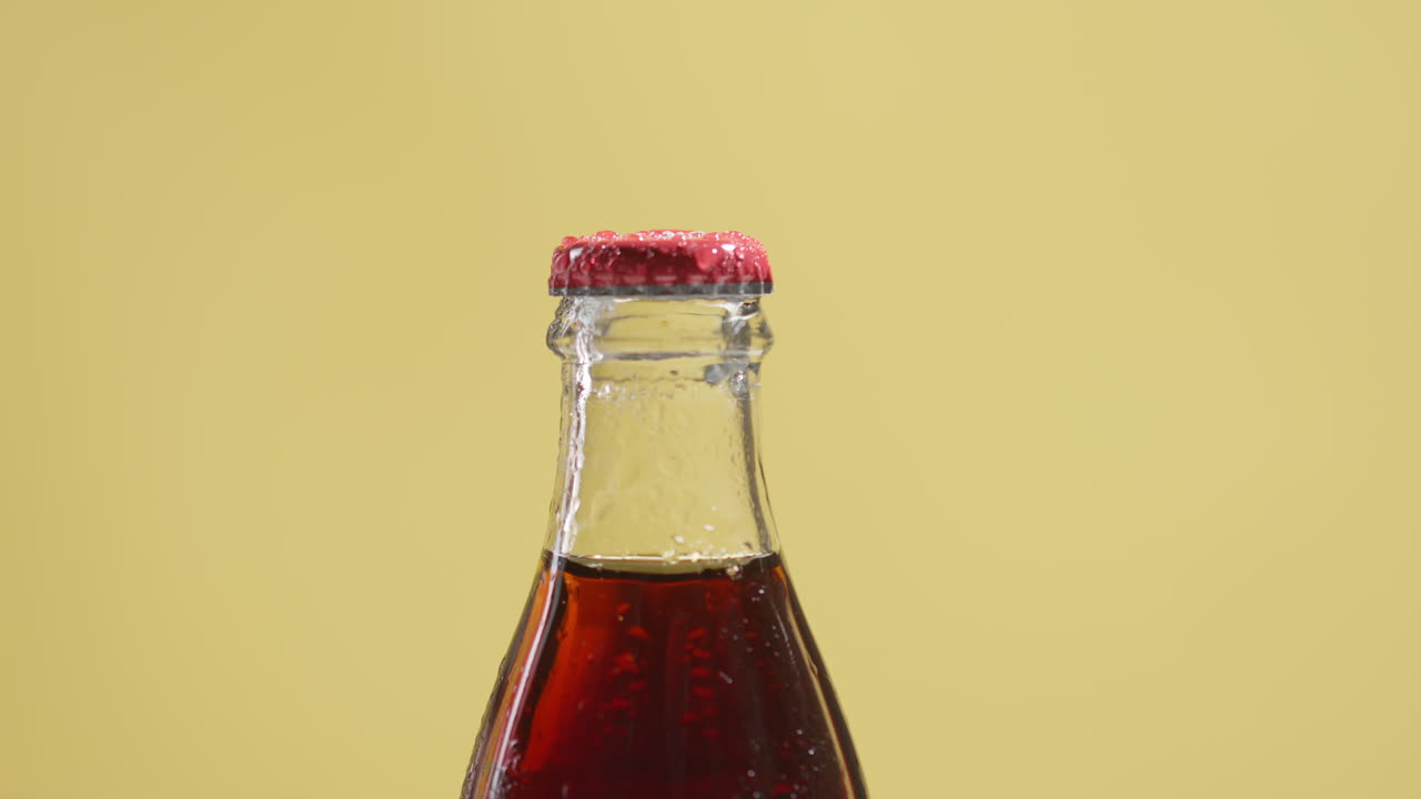 Close Up Shot Of Person Putting Down Bottle Of Cold Beer Or Soft Drink With Metal Cap And Condensation Droplets