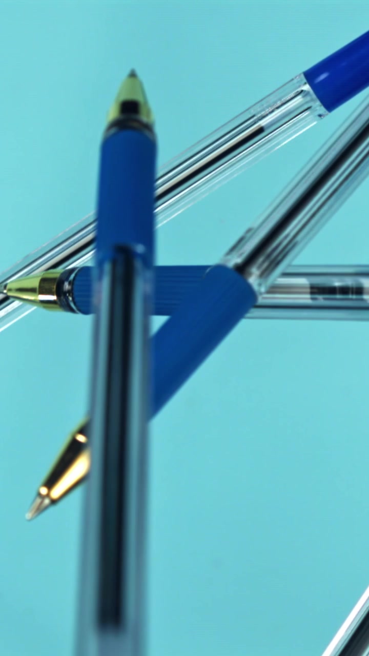 Close-up of Blue Ballpoint Pens on a Light Blue Background