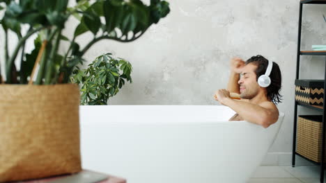 man relaxing and singing in a bathtub
