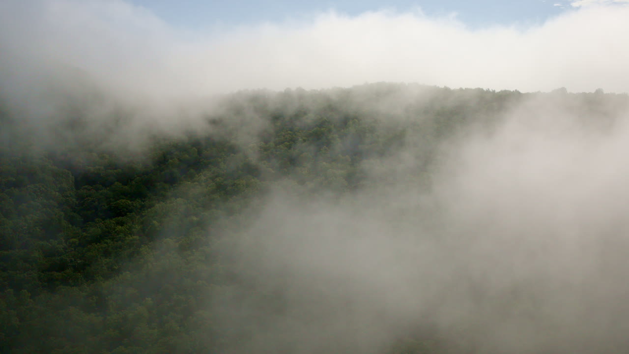 Drone flying toward fog-wrapped summits of the Smokies