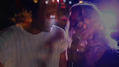 male singer and female singer performing music under colored stage lights, with animated sound bars
