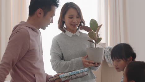 happy asian family moving into new home owners with children helping parents move into house carrying furniture enjoying teamwork together with kids real estate property investment 4k footage