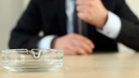 businessman smoking cigarette in office 1