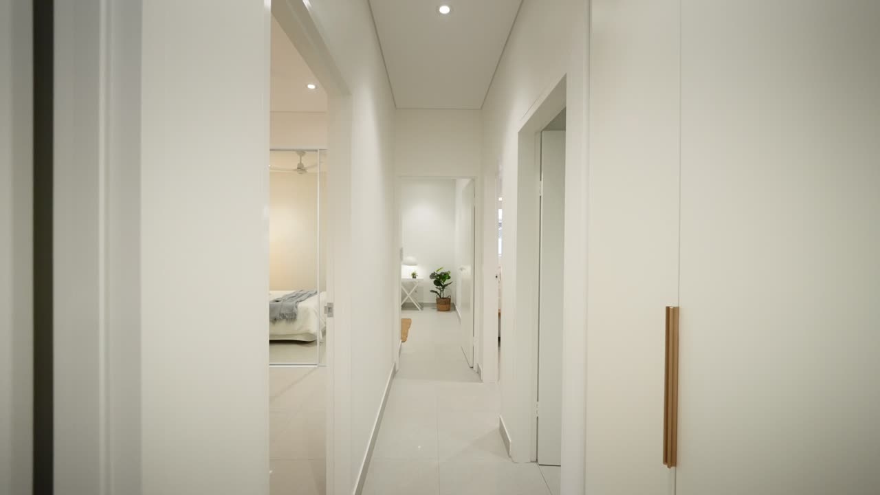 Sleek modern hallway leading to a bedroom in a luxury small home, featuring minimalist design elements. Interior of house home staged for real estate.