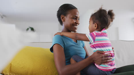 Feliz-Madre-E-Hija-Afroamericana-Sentadas-En-El-Sofá-Y-Tocándose-La-Frente