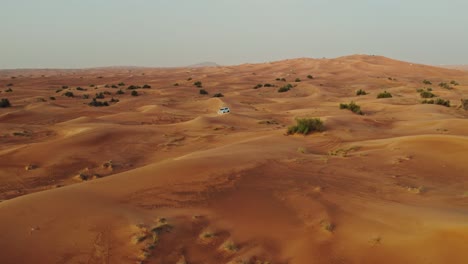 desert landscape with sand dunes and vehicle