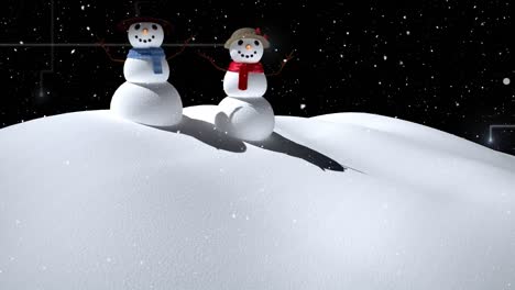 snow falling over snowman and snowwoman on winter landscape against black background